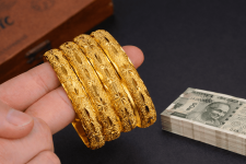 Golden bangles and Indian rupees.png
